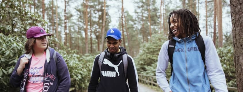 Three young people walking in nature